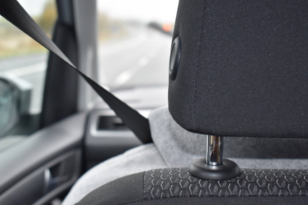 person wearing the safety belt in a car